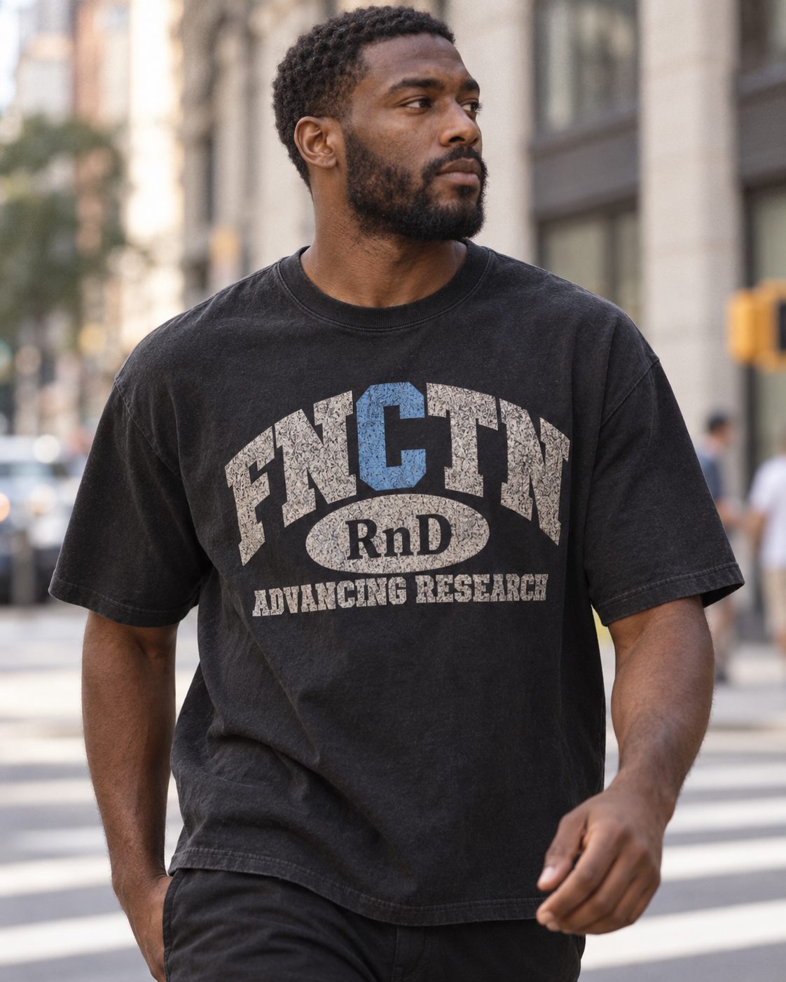 Walking a downtown crosswalk in the Black Varsity Tee