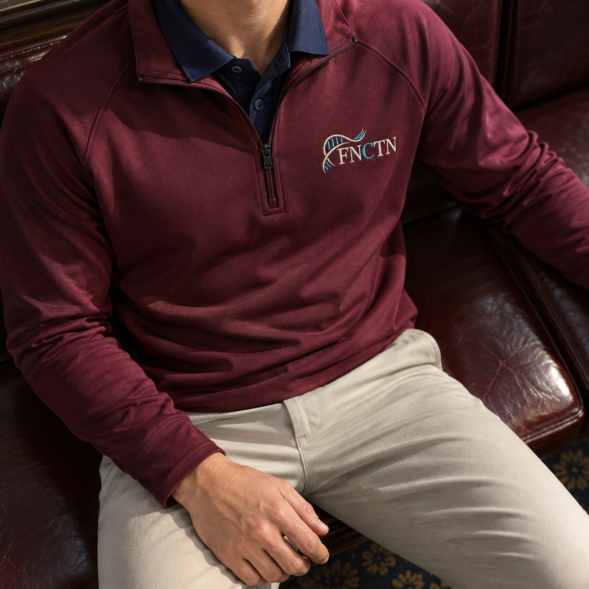 The Maroon quarter zip worn over the Navy polo, the embroidered chest mark at the left chest